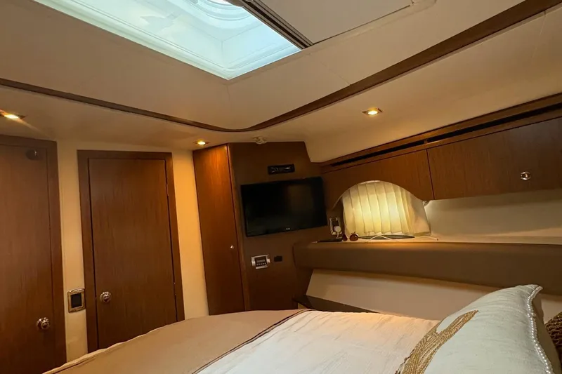 Slide: The Image of Luxurious interior of a 2015 Meridian 441 Sedan yacht bedroom with skylight and TV. - 18