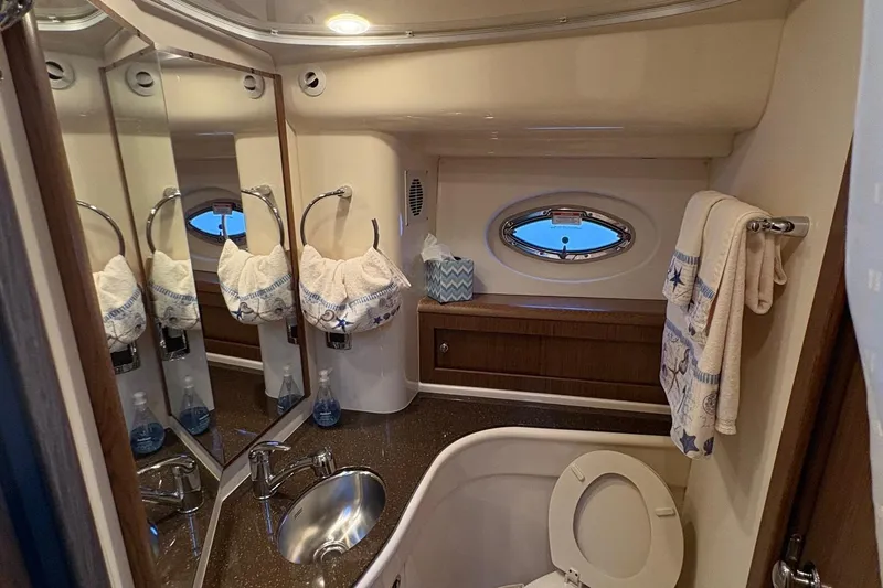 Slide: The Image of Luxurious bathroom in 2015 Meridian 441 Sedan yacht with elegant fixtures and porthole window. - 19