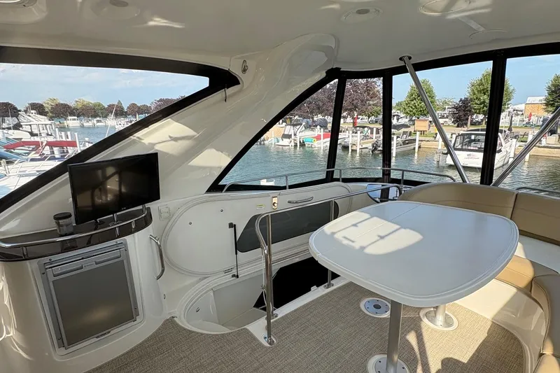 Slide: The Image of Interior of 2015 Meridian 441 Sedan yacht with seating, table, and waterfront view. - 5