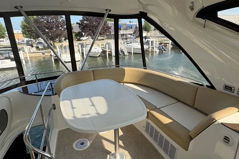 Slide: The Image of Interior of 2015 Meridian 441 Sedan yacht with seating and table, overlooking marina. - 6