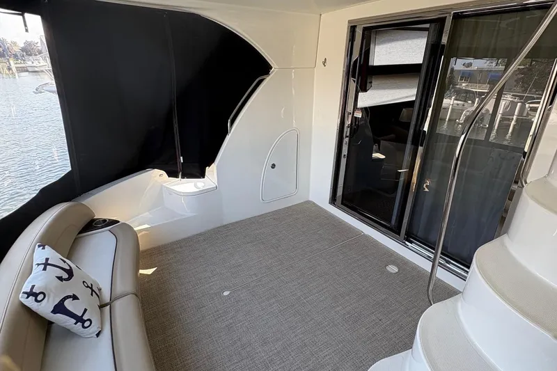 Slide: The Image of 2015 Meridian 441 Sedan yacht interior with seating, anchor pillow, and stairs. - 8