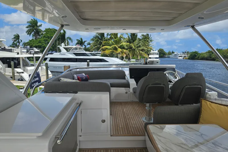 Slide: The Image of Luxurious 2022 Azimut 66 yacht interior with elegant seating and scenic waterfront view. - 10