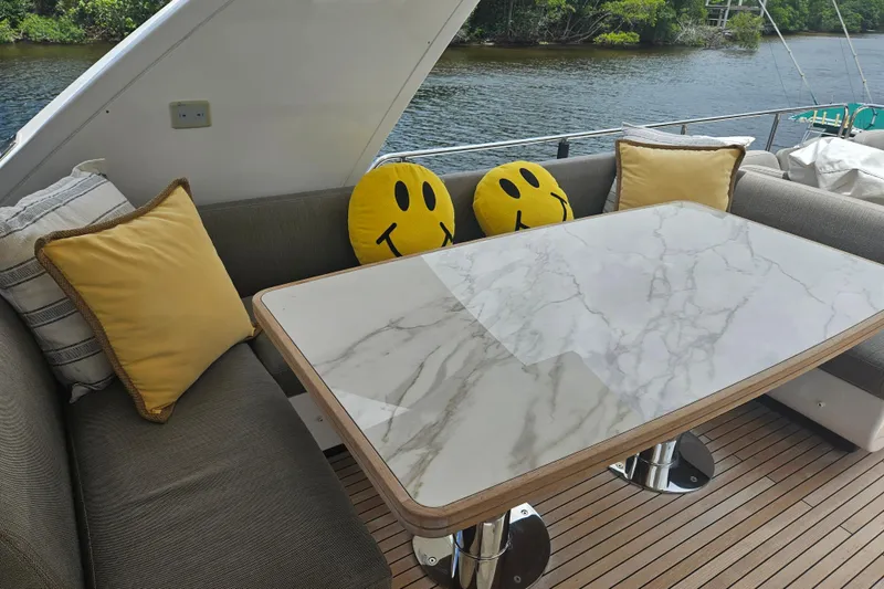 Slide: The Image of Outdoor seating area on 2022 Azimut 66 yacht with marble table and smiley cushions. - 11