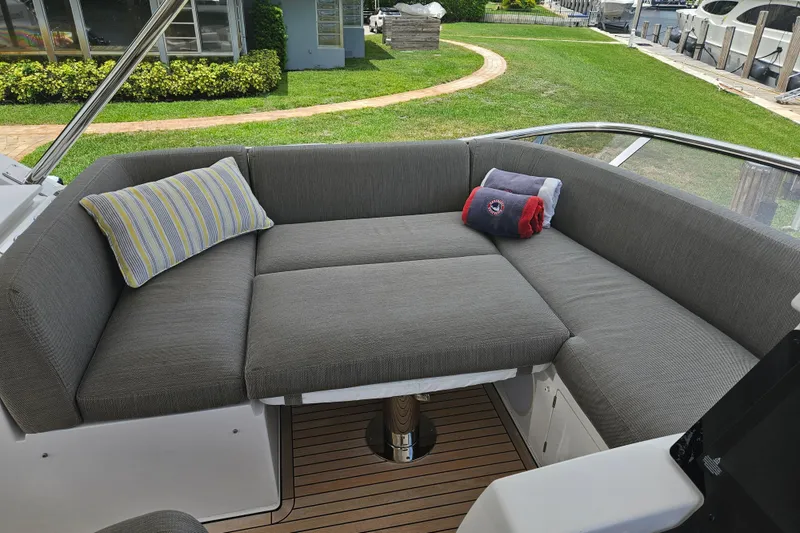 Slide: The Image of Luxurious seating area on 2022 Azimut 66 yacht with gray cushions and decorative pillows. - 16
