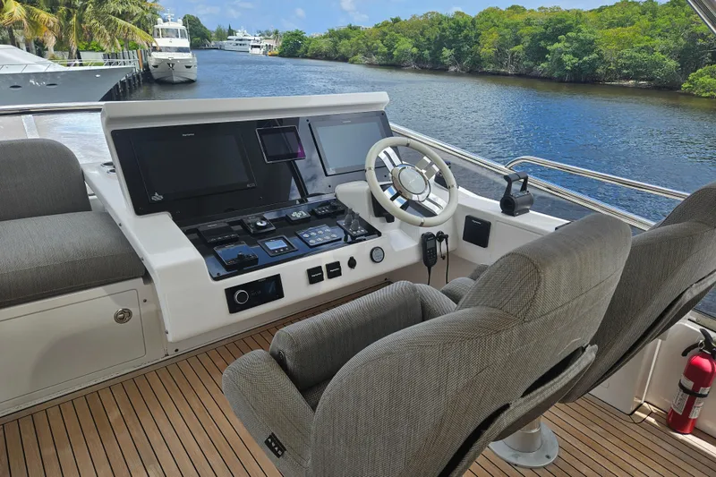 Slide: The Image of Helm of 2022 Azimut 66 yacht with modern controls and river view. - 17