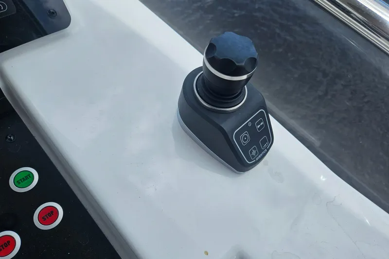 Slide: The Image of Joystick control on 2022 Azimut 66 yacht dashboard with start and stop buttons. - 19