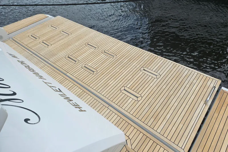 Slide: The Image of Luxury Azimut 66 yacht deck, 2022 model, with sleek wooden finish by the water. - 20
