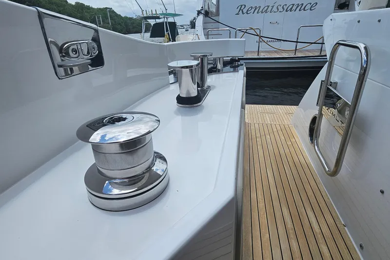Slide: The Image of 2022 Azimut 66 yacht deck with polished winches and teak flooring. - 22