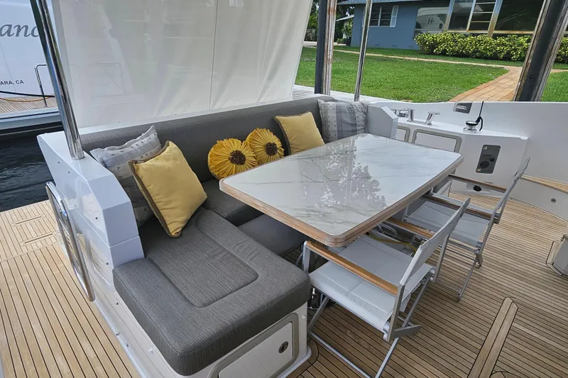 Slide: The Image of Luxurious seating area on 2022 Azimut 66 yacht with elegant cushions and table. - 23