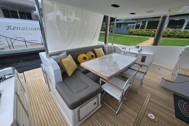 Slide: The Image of Luxurious 2022 Azimut 66 yacht deck with elegant seating and dining area. - 24