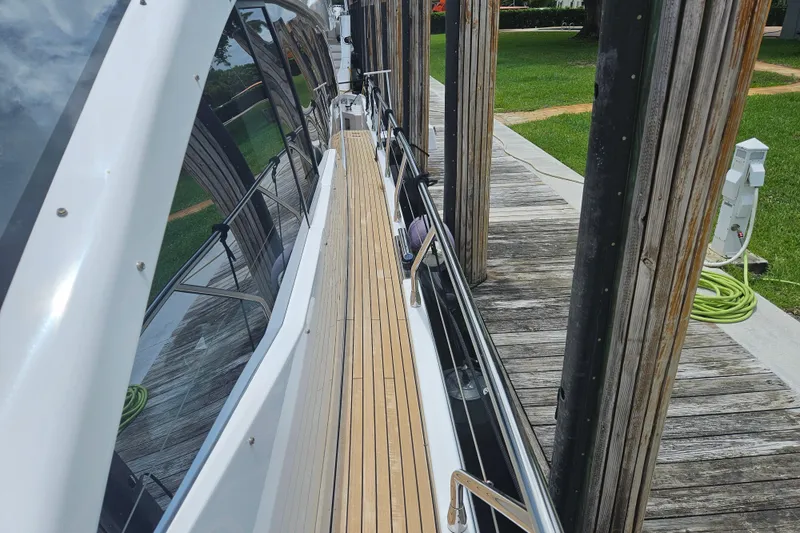 Slide: The Image of 2022 Azimut 66 yacht docked, showcasing sleek design and wooden deck. - 26