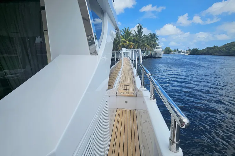 Slide: The Image of Side view of 2022 Azimut 66 yacht with wooden deck and scenic waterway. - 27