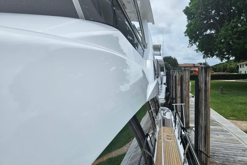 Slide: The Image of Side view of a 2022 Azimut 66 yacht docked at a marina. - 28