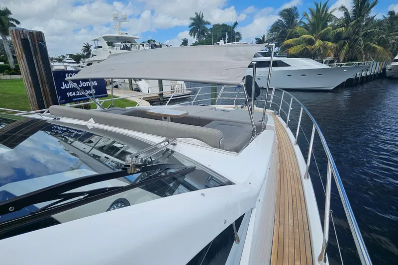 Slide: The Image of 2022 Azimut 66 yacht with sleek design, docked near palm trees and waterway. - 29