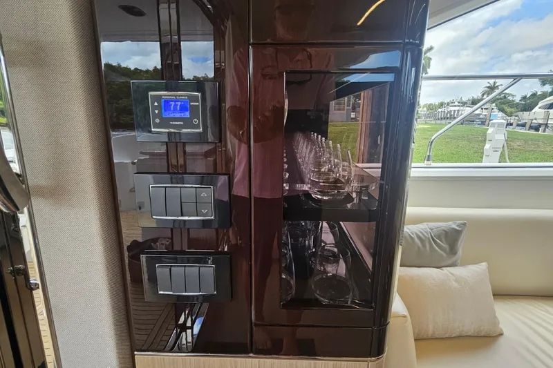 Slide: The Image of Luxurious interior of 2022 Azimut 66 yacht featuring control panel and glassware display. - 33