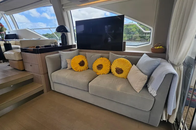 Slide: The Image of Luxurious Azimut 66 yacht interior with cozy sofa, sunflower pillows, and scenic window view. - 35