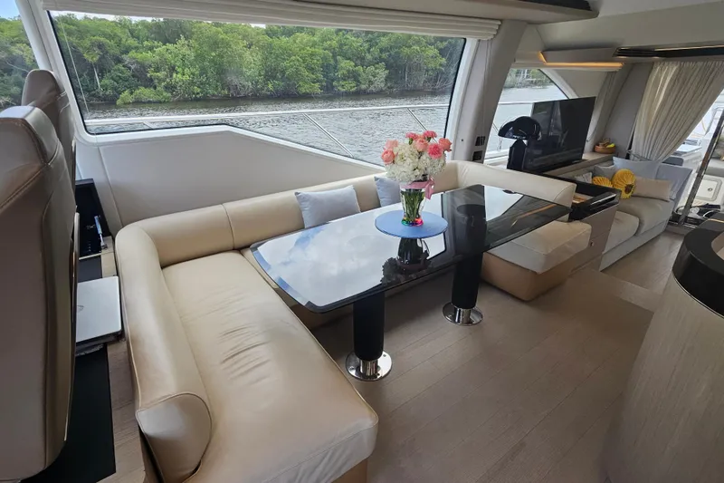 Slide: The Image of Luxurious interior of 2022 Azimut 66 yacht with elegant seating and scenic window view. - 40