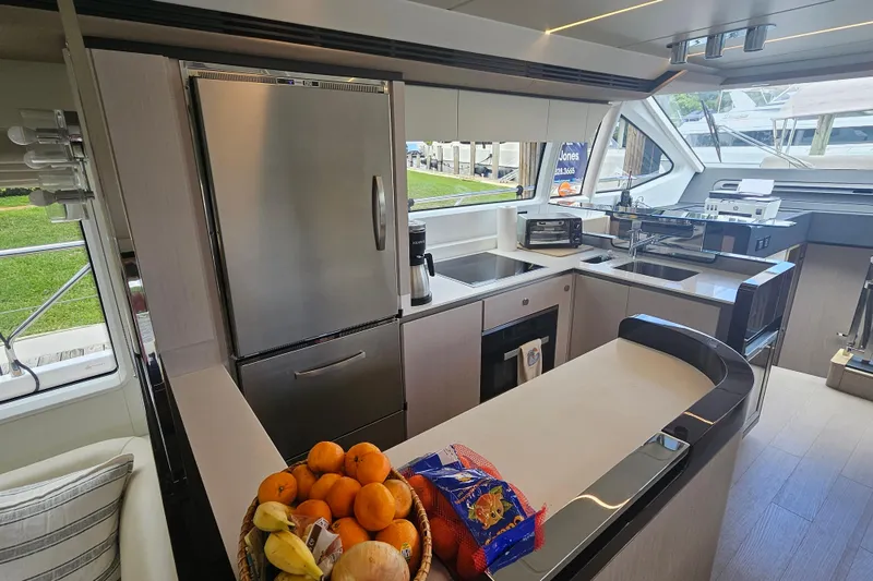 Slide: The Image of Luxurious 2022 Azimut 66 yacht kitchen with modern appliances and fruit basket. - 41