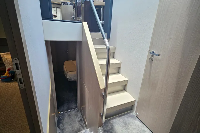 Slide: The Image of Interior staircase of 2022 Azimut 66 yacht, featuring modern design and sleek finishes. - 47