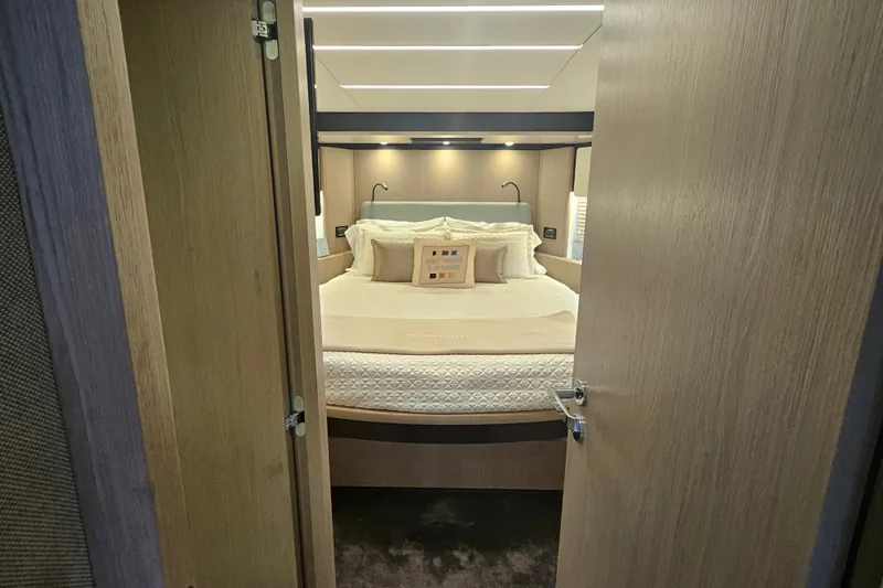 Slide: The Image of Luxurious bedroom interior of 2022 Azimut 66 yacht with elegant bedding and modern lighting. - 48