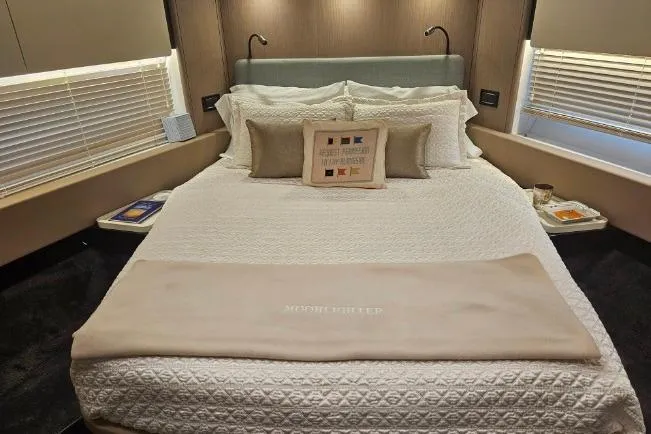 Slide: The Image of Luxurious bedroom interior of 2022 Azimut 66 yacht with elegant bedding and modern decor. - 49