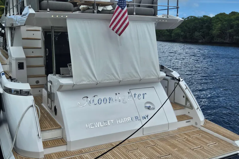 Slide: The Image of Azimut 66 yacht, 2022 model, docked with American flag, named "Moonlighter." - 5