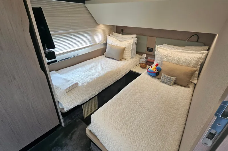 Slide: The Image of Luxurious twin cabin interior of 2022 Azimut 66 yacht with elegant bedding and decor. - 54