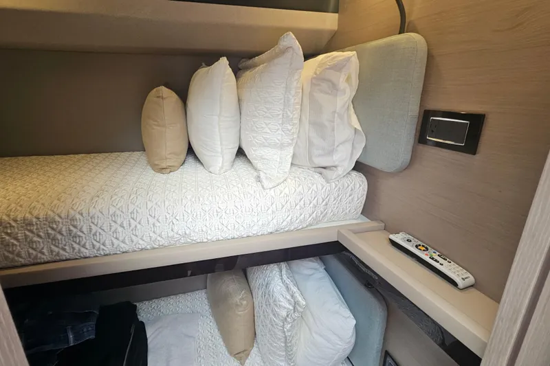 Slide: The Image of Cozy cabin interior of 2022 Azimut 66 yacht with bunk beds and remote control. - 58