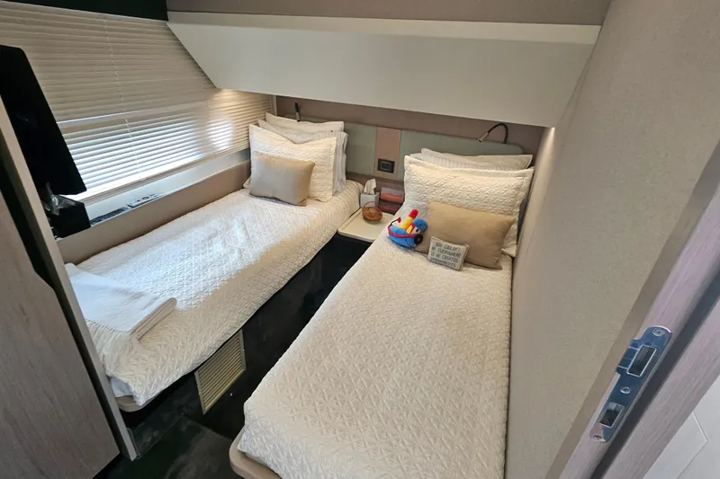 Slide: The Image of Luxurious twin cabin in 2022 Azimut 66 yacht with elegant bedding and modern decor. - 59