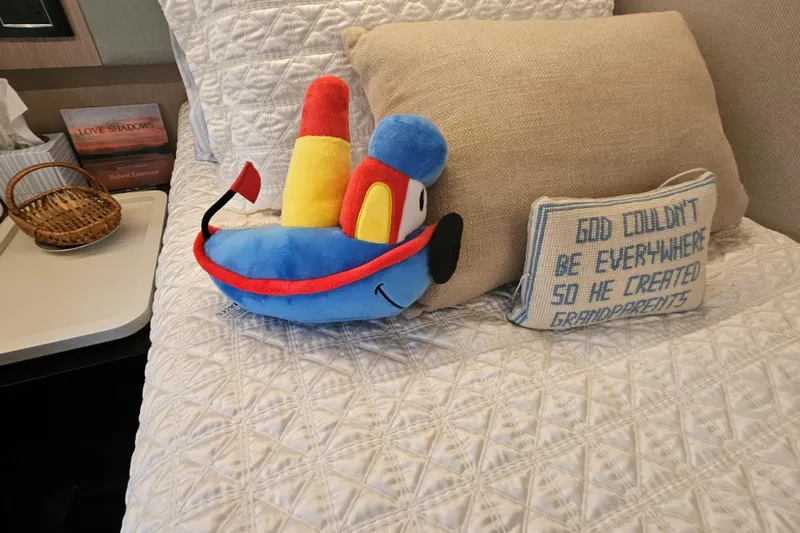 Slide: The Image of Plush toy and decorative pillows on a cozy bed in an Azimut 66 yacht cabin. - 60