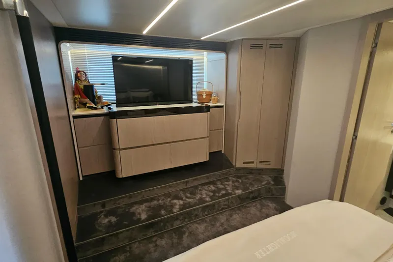 Slide: The Image of Luxurious interior of 2022 Azimut 66 yacht with modern TV and elegant cabinetry. - 63