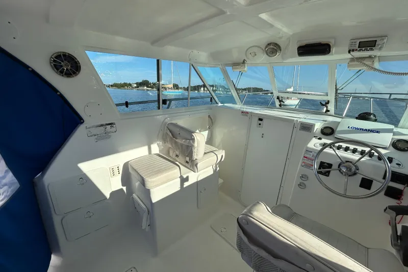 Slide: The Image of 2011 Baha Cruisers 277 GLE boat interior with steering wheel and navigation equipment. - 11