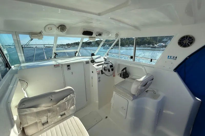 Slide: The Image of 2011 Baha Cruisers 277 GLE boat interior with helm, seats, and water view. - 14