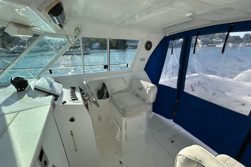Slide: The Image of 2011 Baha Cruisers 277 GLE boat interior with helm, seating, and water view. - 16