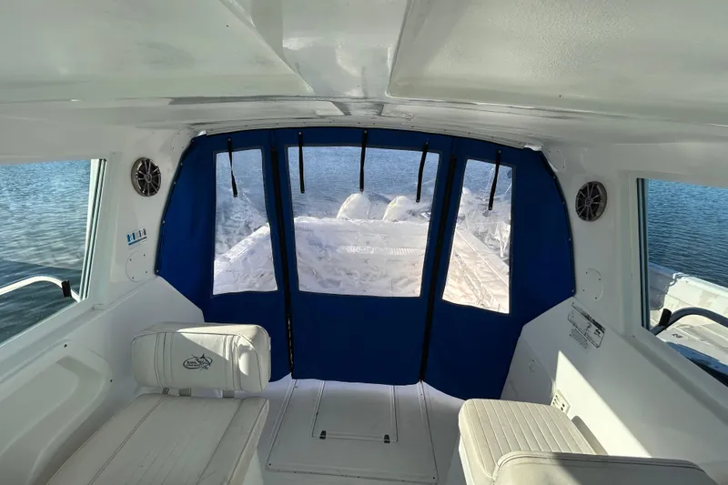 Slide: The Image of Interior view of 2011 Baha Cruisers 277 GLE boat with blue curtains and seating. - 17