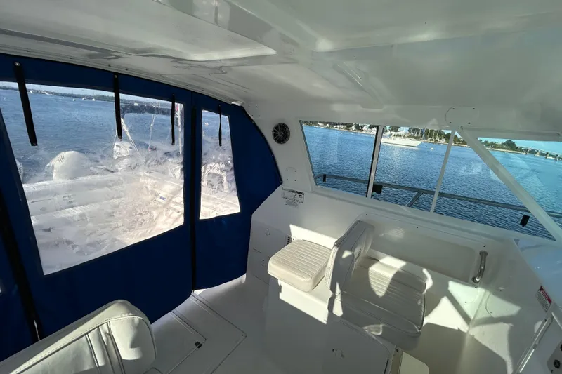 Slide: The Image of 2011 Baha Cruisers 277 GLE interior with blue curtains and scenic water view. - 18