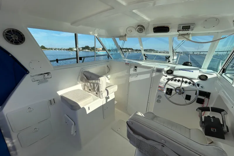 Slide: The Image of 2011 Baha Cruisers 277 GLE boat interior with steering wheel and navigation equipment. - 21
