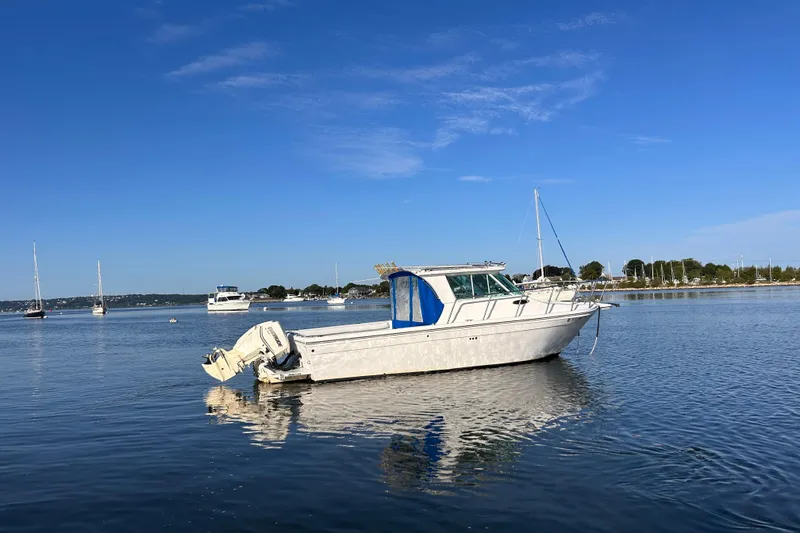 Slide: The Image of 2011 Baha Cruisers 277 GLE boat on calm water under clear blue sky. - 3