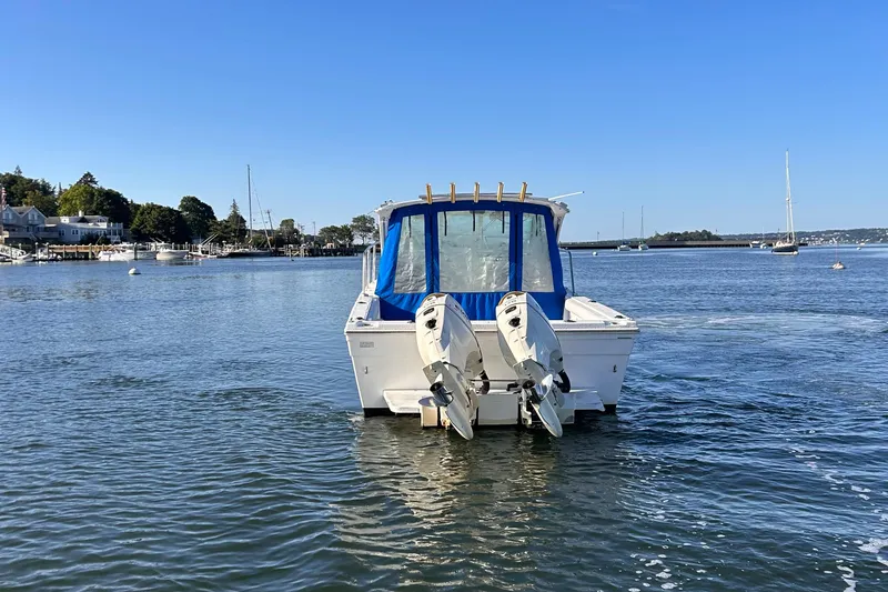 Slide: The Image of 2011 Baha Cruisers 277 GLE boat with dual engines on calm water. - 4