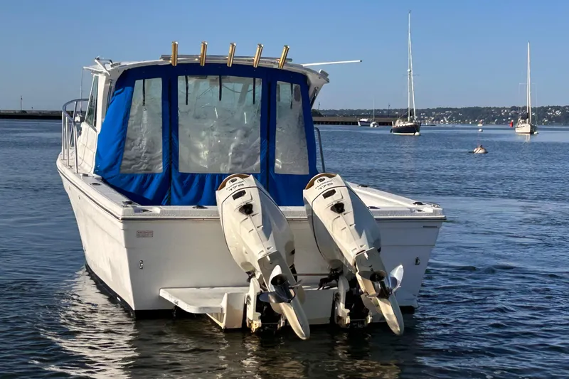 Slide: The Image of 2011 Baha Cruisers 277 GLE boat with dual outboard motors on calm water. - 5