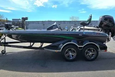 Slide: The Image of 2019 Ranger Z519 boat with dual axles, sleek design, and modern features, parked outdoors. - 3