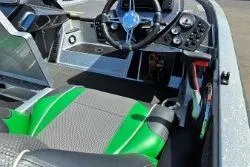 Slide: The Image of 2019 Ranger Z519 boat interior with green-accented seats and modern steering console. - 4