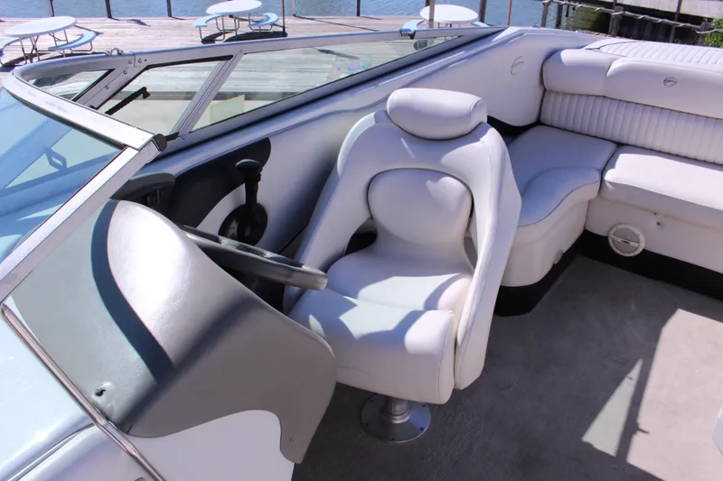 Slide: The Image of 2005 Crownline 266 BR boat interior with white seating and steering wheel. - 3