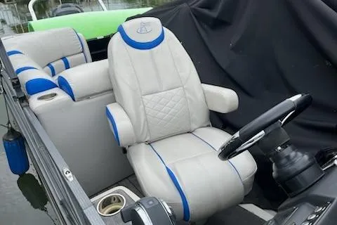 Slide: The Image of 2018 Misty Harbor S2385SU boat interior with plush seating and steering wheel. - 2