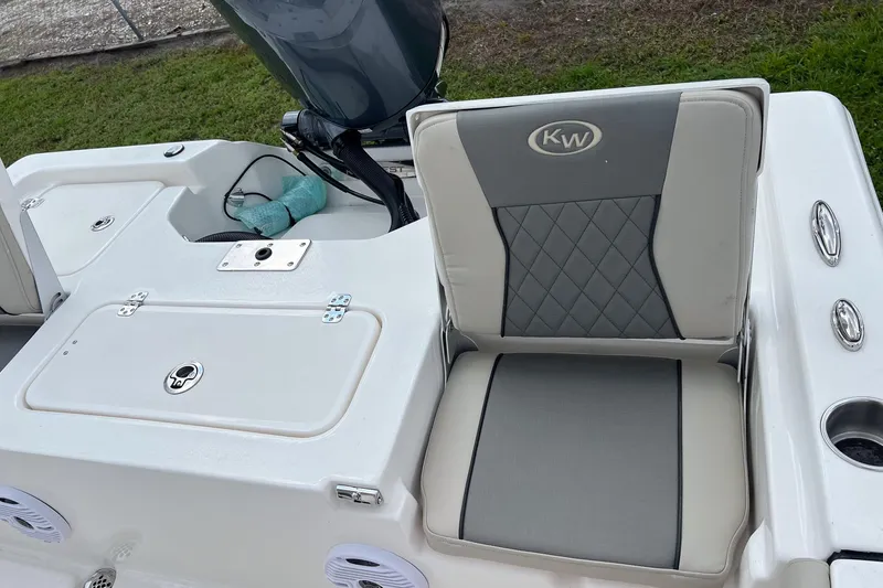 Slide: The Image of 2026 Key West 210 Bay Reef boat interior with seating and storage compartments. - 16