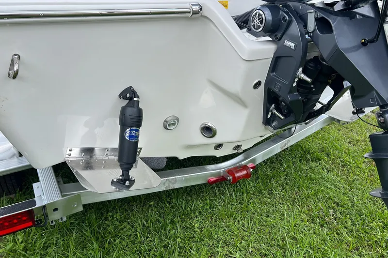 Slide: The Image of 2026 Key West 210 Bay Reef boat on trailer, showing motor and trim tab details. - 19