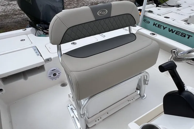 Slide: The Image of 2026 Key West 210 Bay Reef boat interior with storage compartments and seating. - 8