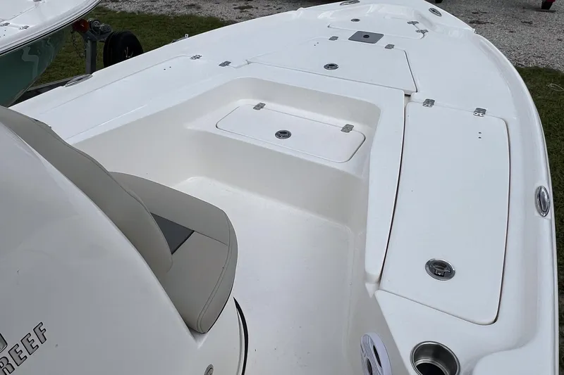 Slide: The Image of 2026 Key West 210 Bay Reef boat with open storage compartments and seating area. - 9