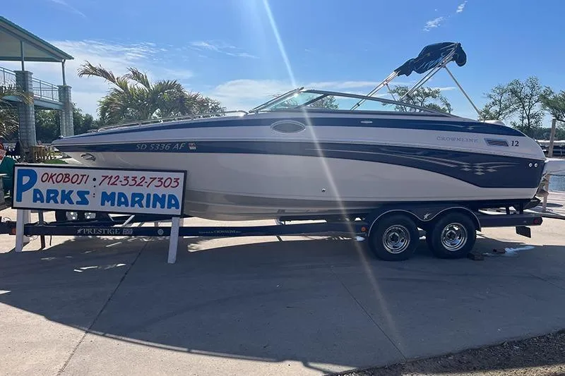 The Image of 2005 Crownline 266 BR boat on trailer at Parks Marina, sunny day. - 1