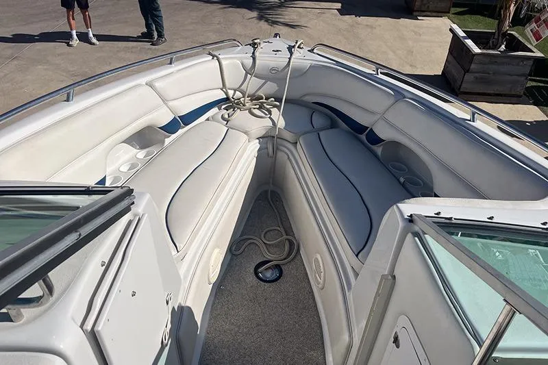 Slide: The Image of 2005 Crownline 266 BR boat interior with white seating and rope on deck. - 3